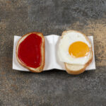 Delicious crispy toasts with fried egg and jam