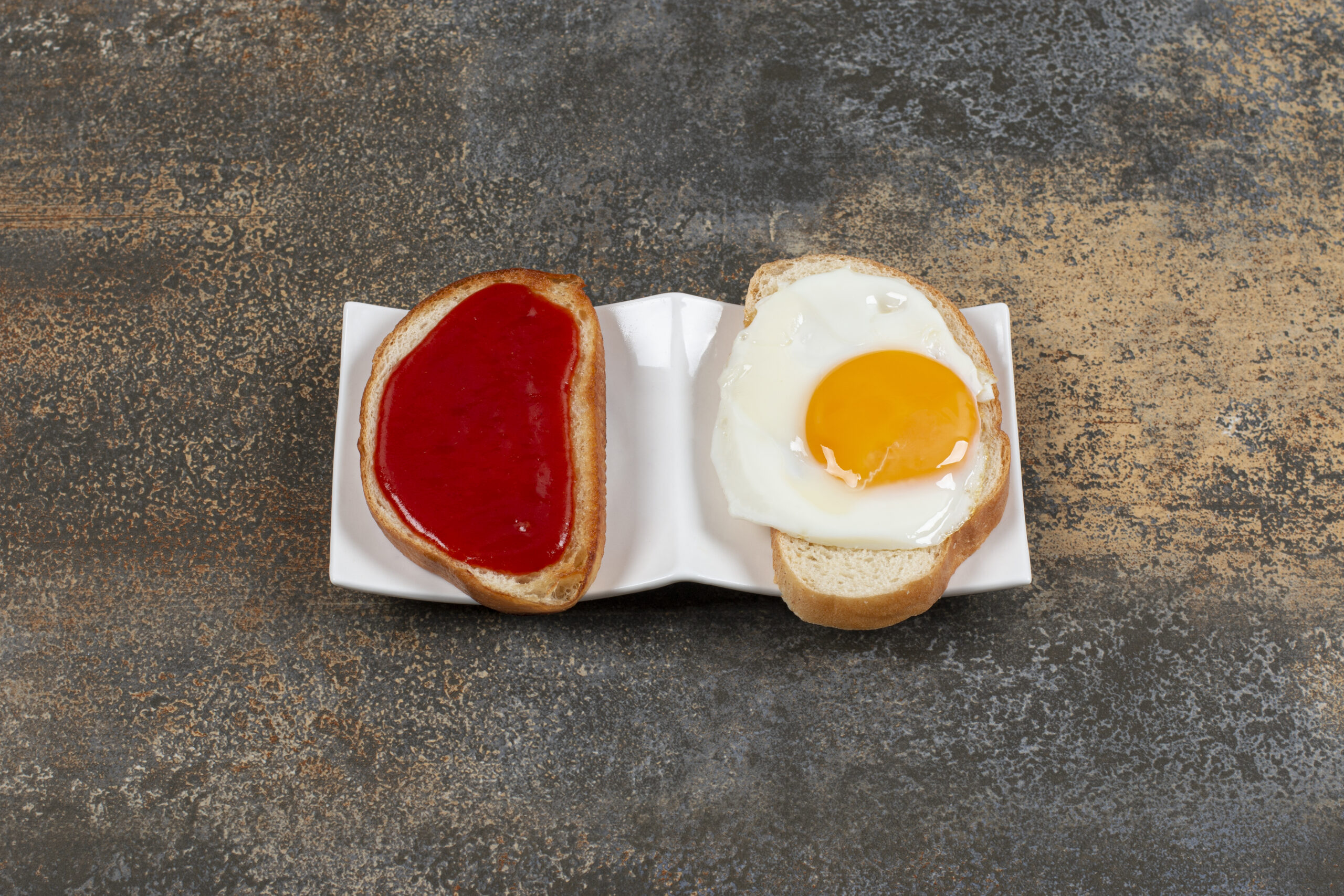 Delicious crispy toasts with fried egg and jam